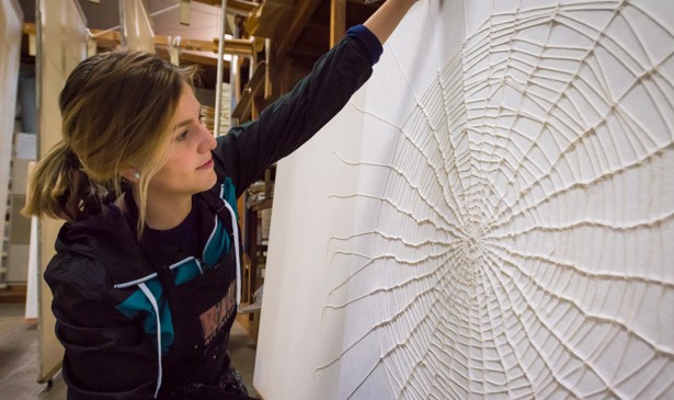 Artist Richelle Gribble with her cotton spider web on kozo washi paper, created during her artist-in-residency in Japan. (Naoki Isoda / Awagami Factory)