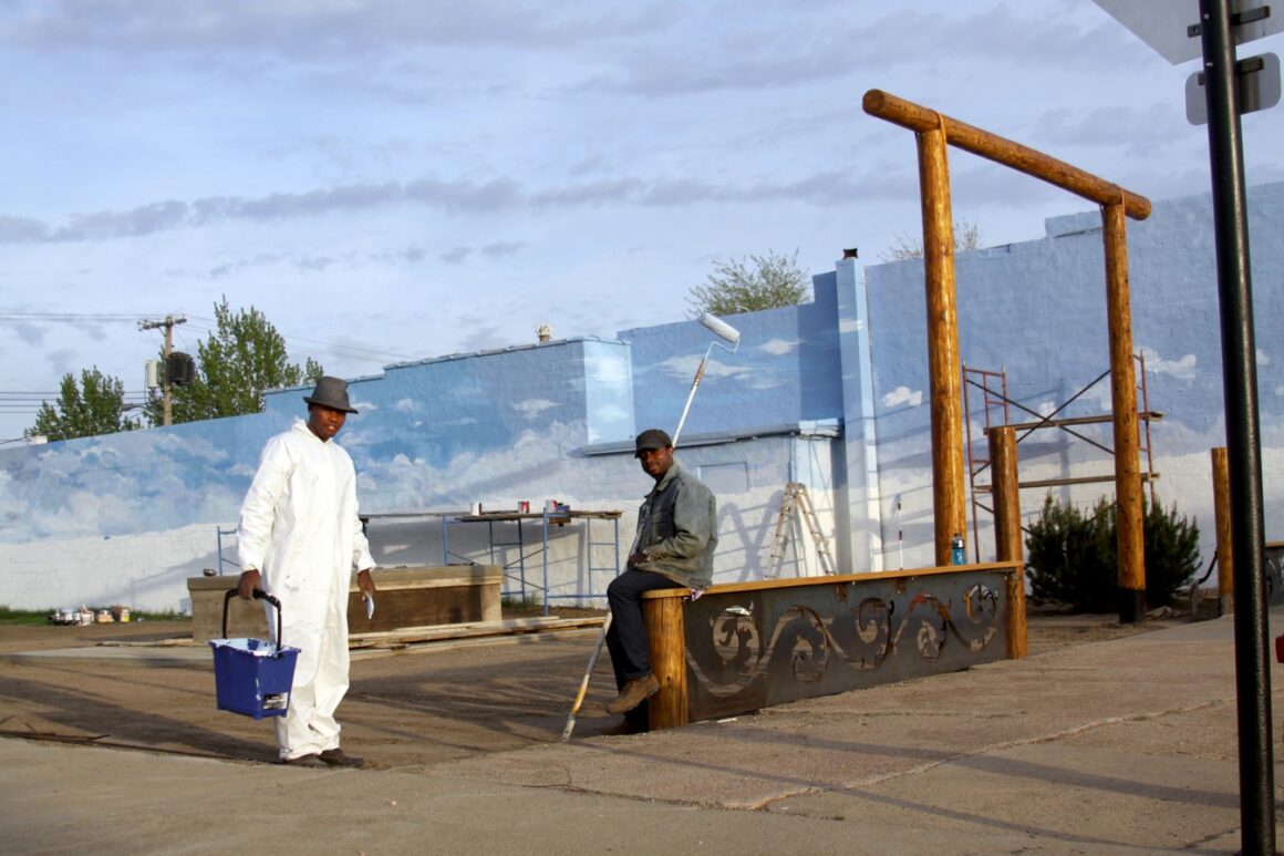 two people with paint cans
