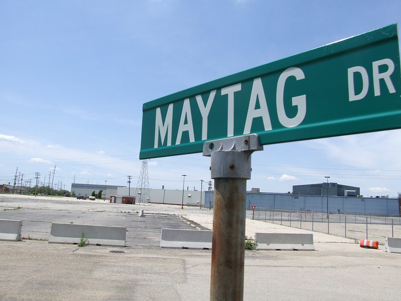 The street sign, Maytag Drive, in the foreground; the former Maytag plant in Galesburg, Illinois in the background.