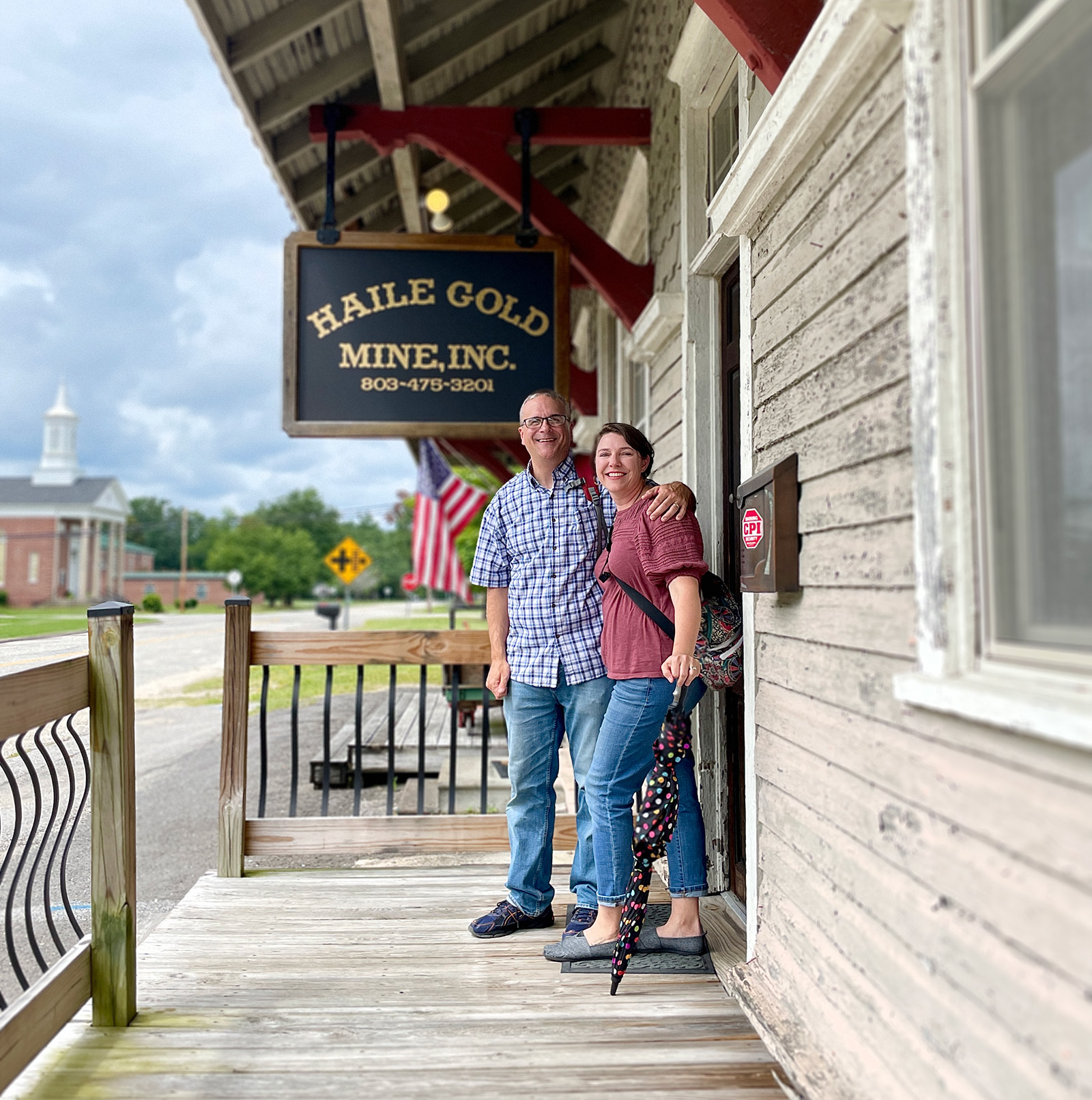 Scott and Tiffany Whaley stop for a picture in front of the old Kershaw Train Depot renewed as office spaces and a museum. Photo by Michelle Ellia.