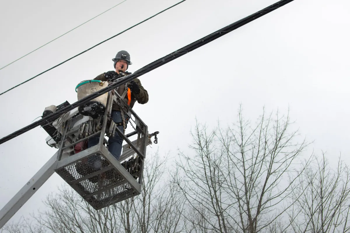 Josh Landry installs fiber-optic cable in Dedham, Maine, as part of a broadband project that is putting in 60 miles of cable in the town of 1,600. (Photo by Carolyn Campbell)