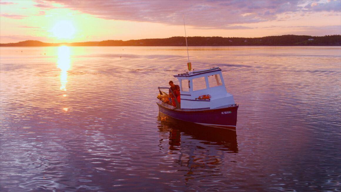 Young fisherman Elijah Brice, of Eastport, Maine, at sunrise in his boat. He envisions a sustainable future for his industry and his community.
