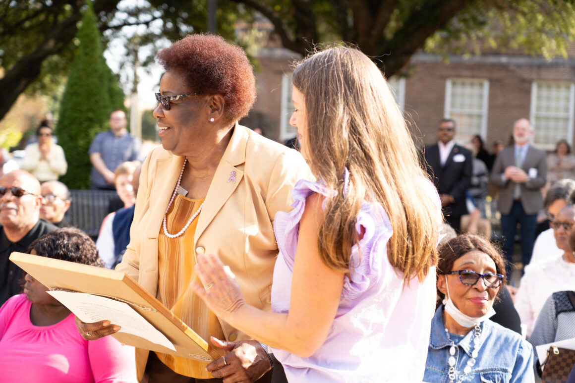 Laverne Greene-Leech (left) is presented a copy of the program for the memorial by MUW University Counsel Karen Clay. (Photo Chris Jenkins.)