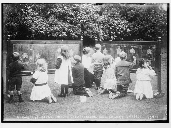Children doing nature drawings, in antique photo.